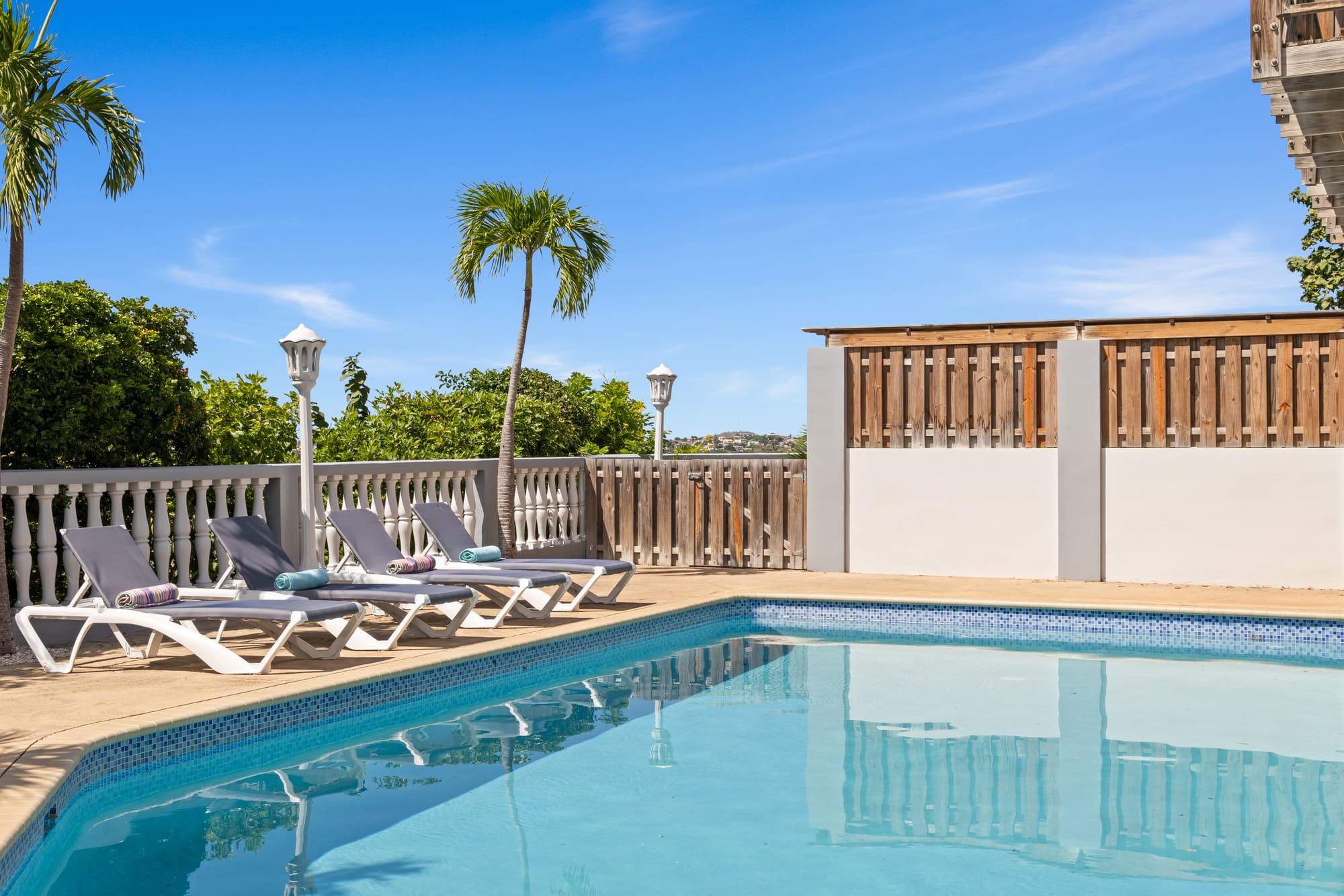 The pool at Casa Hilltop Breeze surrounded by palm trees